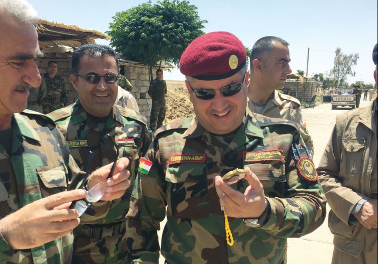Gen. Tariq Harni smiles at a gift brought from Israel.