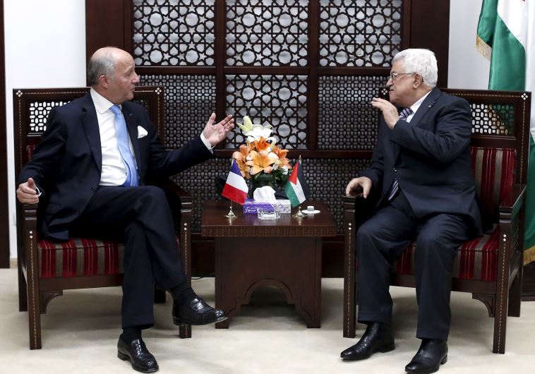 France's Foreign Minister Laurent Fabius (L) gestures as he meets Palestinian President Mahmoud Abbas