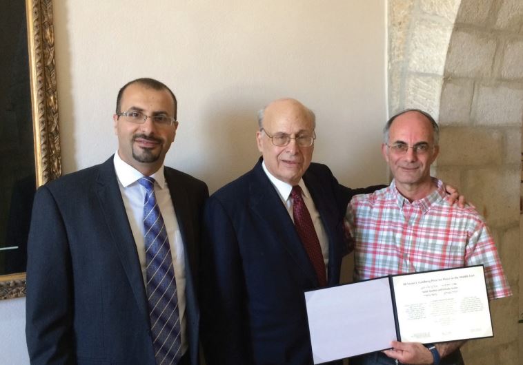 Victor J. Goldberg (center), poses yesterday at the Notre Dame Center in Jerusalem with Salah Alladin (left) and Yehuda Stolov,