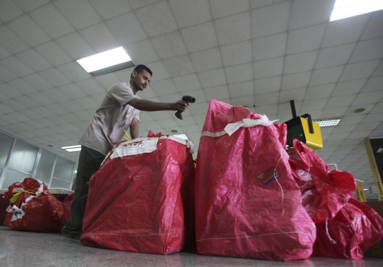 A DHL worker checks parcels at Sanaa International Airport.
