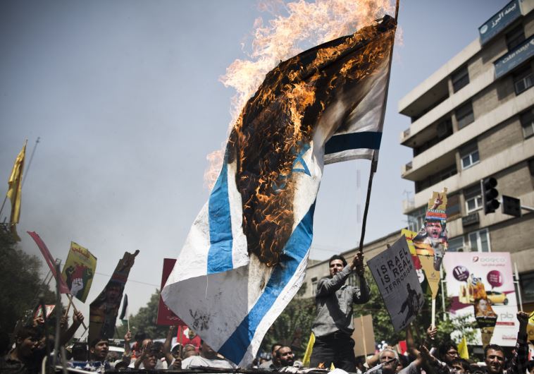 Iranian protestors burn an Israeli flag during a demonstration in Tehran on July 25, 2014 to mark the Quds Day