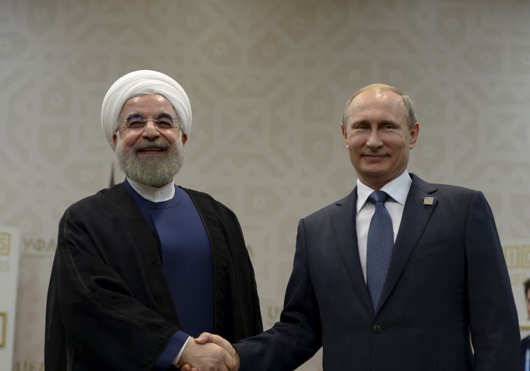 Russian President Vladimir Putin shakes hands with Iran's President Hassan Rouhani during their meeting in Ufa, Russia, July 9, 2015.