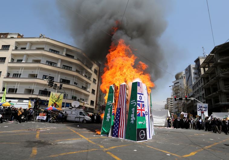 Iranian protesters burn Israeli, American and Saudi Arabian flags during a demonstration to mark the Quds (Jerusalem) International day in Tehran on July 10, 2015.