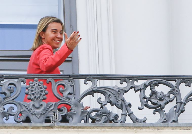 European Union foreign policy chief Federica Mogherini gestures as she stands on the balcony of Palais Coburg, the venue for nuclear talks in Vienna, Austria, July 13, 2015.