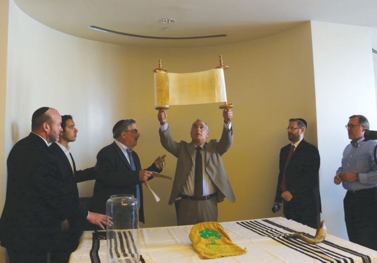 Stuart Steinberg holds the newly finished Torah up for attendees.