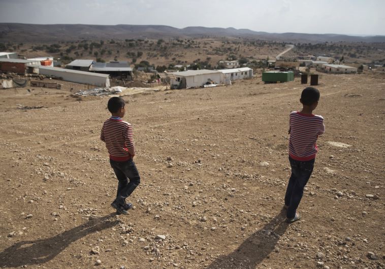 Bedouin boys walk towards a village in southern Israel's Negev desert