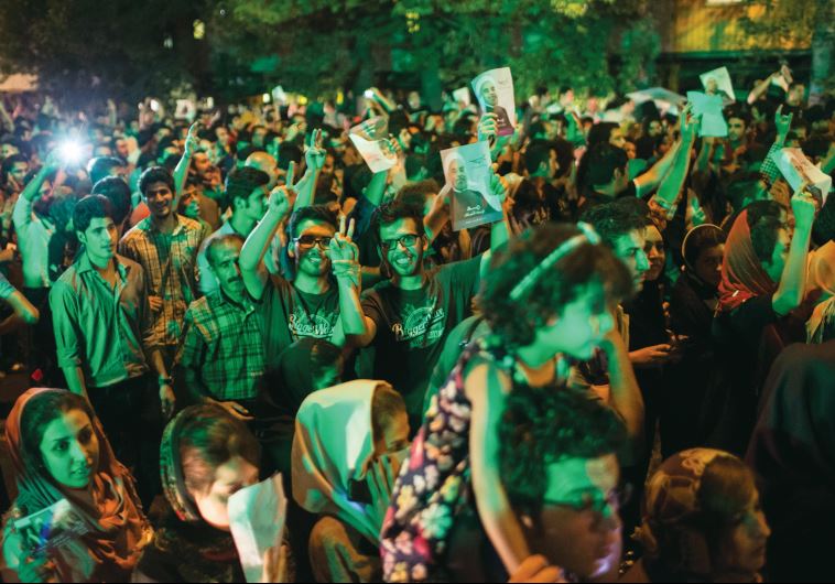 Supporters of President Hassan Rouhani celebrate his victory in Iran’s election on a street in Tehran, 2013.