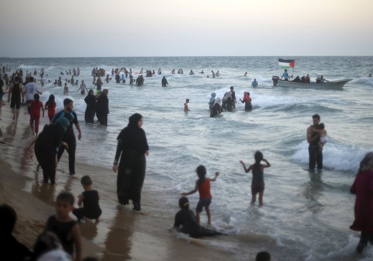 Palestinians enjoy the beach along the Mediterranean Sea in the northern Gaza Strip July 24, 2015. 