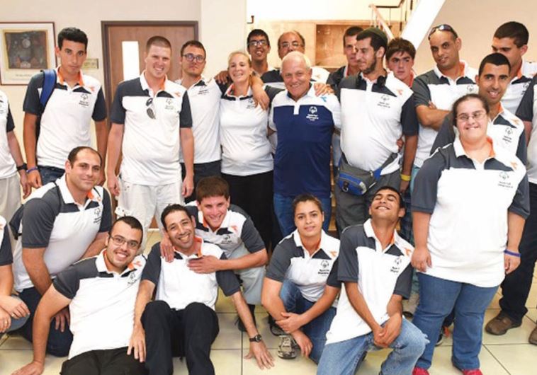 Members of Israel’s delegation to the Special Olympics World Games pose for a photo with Minister of Welfare and Social Services Haim Katz (center in blue) prior to their departure for Los Angeles