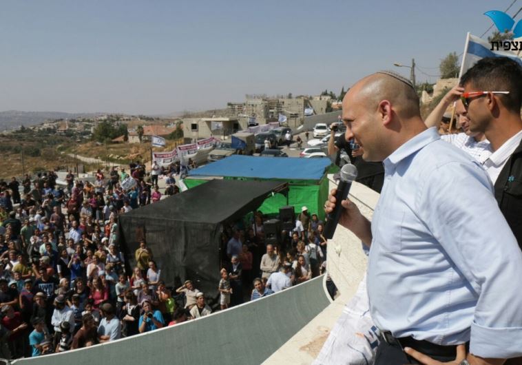 Education Minister Naftali Bennett addresses crowd at Beit El settlement