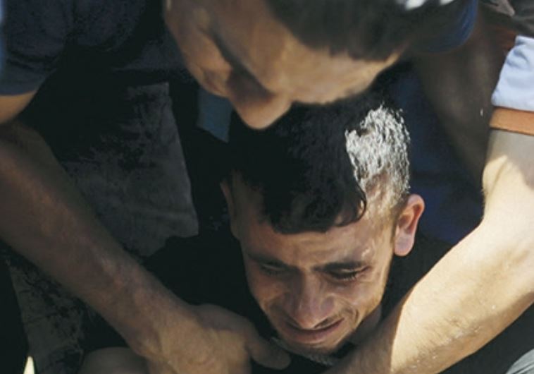 Mourners react as others bury the body of 18-month-old Palestinian Ali Dawabsha,