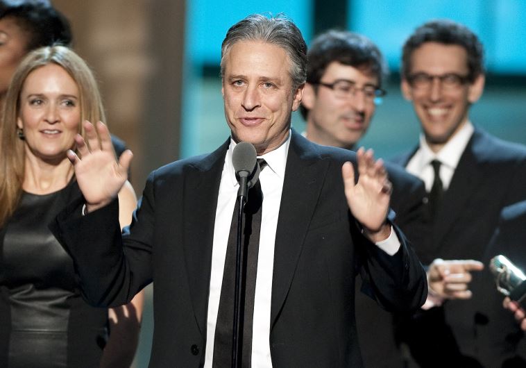 Talk show host Jon Stewart, flanked by his writers and correspondents, speaks after receiving the Best Late Night Comedy Series Award for his show