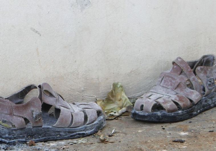 A PAIR of slippers is seen outside a house that had been torched in a suspected attack by Jewish extremists in Duma.