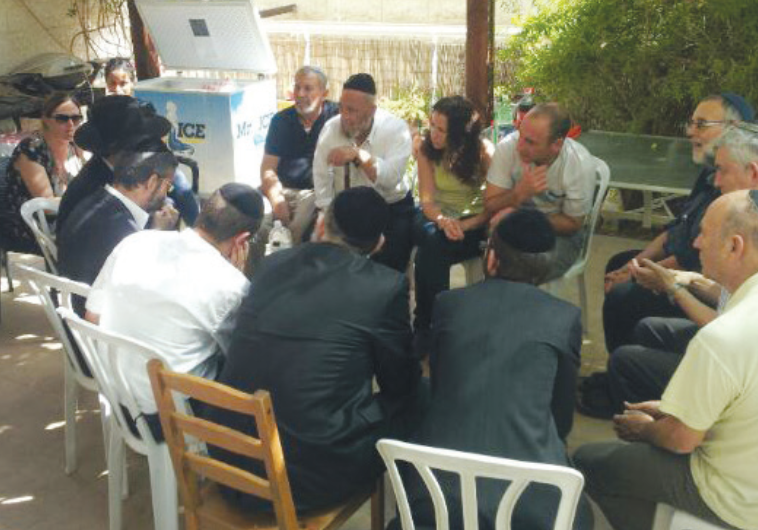 ULTRA-ORTHODOX activists visit the Jerusalem home of the parents of Shira Banki, who was murdered at the Jerusalem Gay Pride Parade two weeks ago, on Friday.
