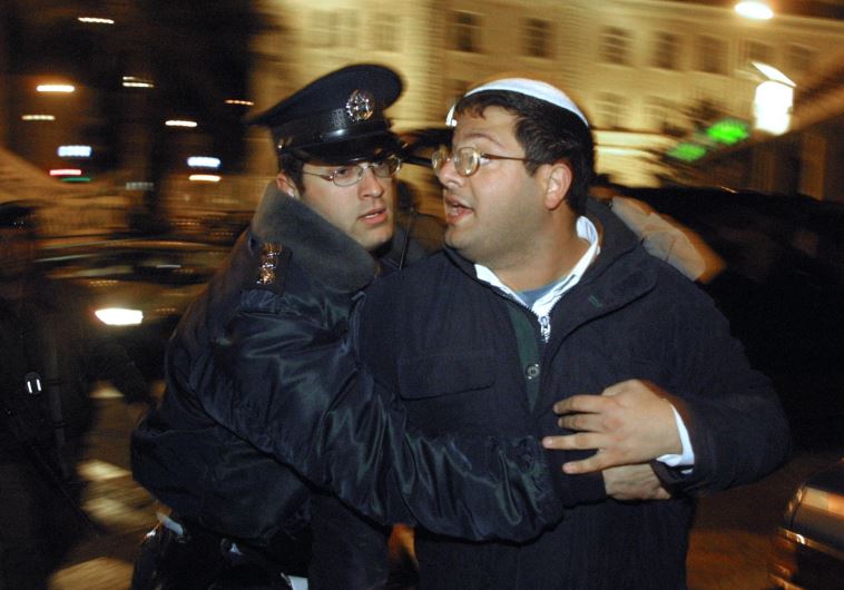 A policeman arrests Israeli right-wing activist Itamar Ben Gvir during a 'Peace Now' demonstration in Jerusalem