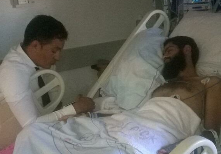 Muhammad Allan, with his lawyer, recovering in hospital