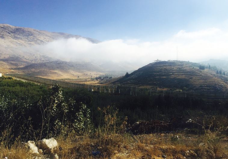 A VIEW ACROSS near Majdal Shams across the Golan border fence into Syria