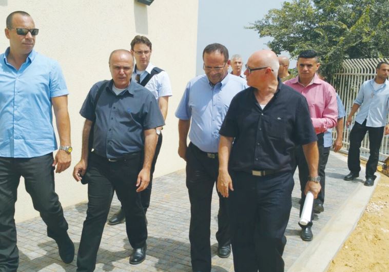 DEPUTY REGIONAL Cooperation Minister Ayoub Kara (center, glancing down) tours the business center near Tulkarm.