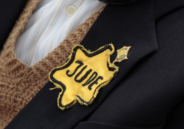 Polish born Mordechai Fox, an 89-year-old Holocaust survivor, wears a yellow Star of David on his jacket during a ceremony marking Holocaust Remembrance Day