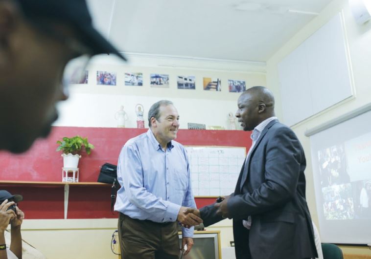 IFCJ President Rabbi Yechiel Eckstein (left) speaks with Pastor Jeremiah Sunday Dairo in south Tel Aviv