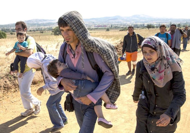 Syrian refugees walk along a road in Serbia, August 24, in an increasingly desperate journey to western Europe