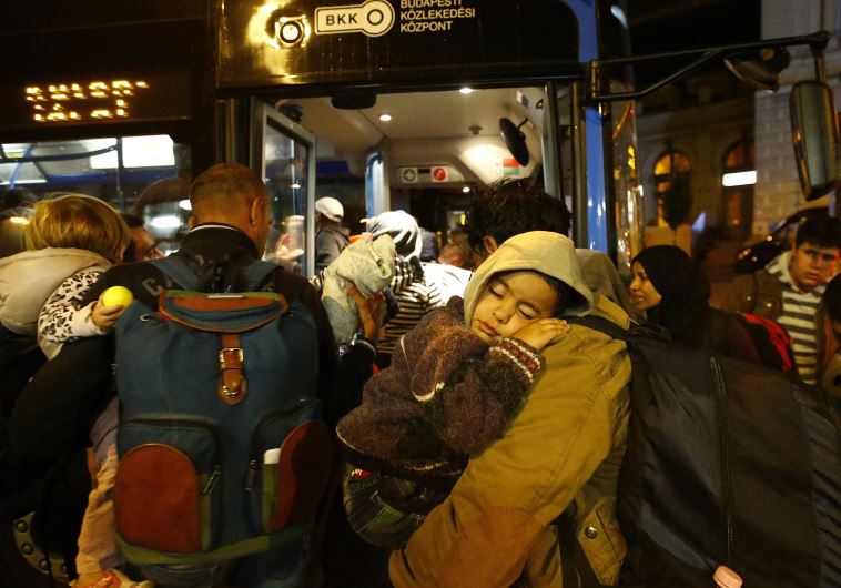 Migrants enter bus, which is supposed to leave to Austria and Germany, in Budapest, Hungary, September 4, 2015.