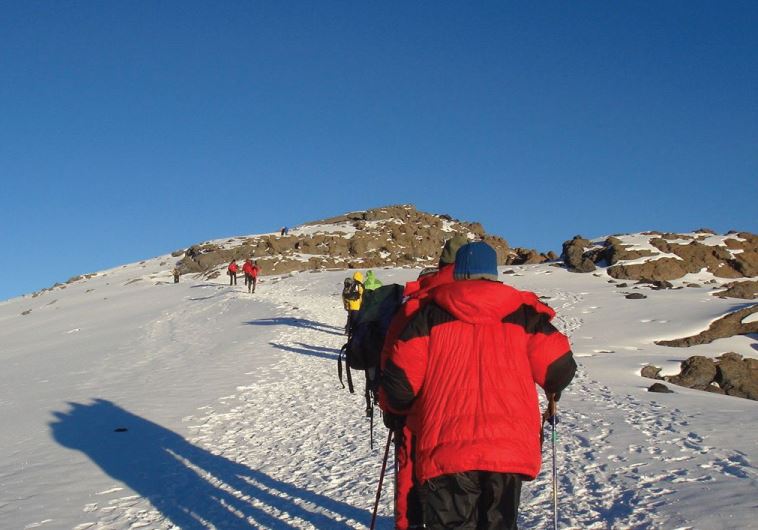 Hikers climb the treacherous terrain of Mount Kilimanjaro to raise funds for children with disabilities