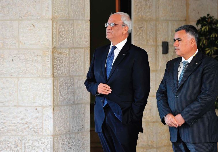 CHIEF PALESTINIAN negotiator Saeb Erakat (left) waits for for a foreign visitor at the Palestinian presidential offices in Ramallah last year