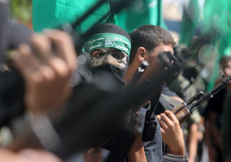 Palestinian Hamas militants take part in a protest against the Israeli police raid on Jerusalem's al-Aksa mosque in Khan Yunis