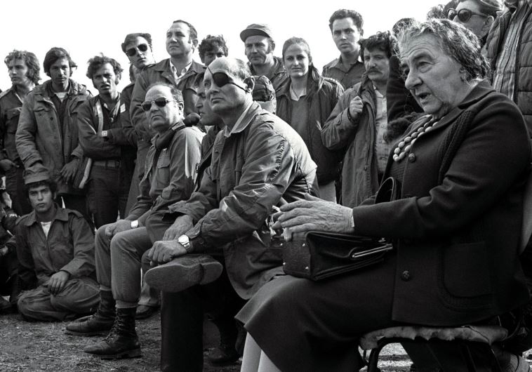 Then-prime minister Golda Meir (R) and her defense minister, Moshe Dayan, meet with Israeli soldiers at a base on the Golan Heights after intense fighting during the 1973 Yom Kippur War