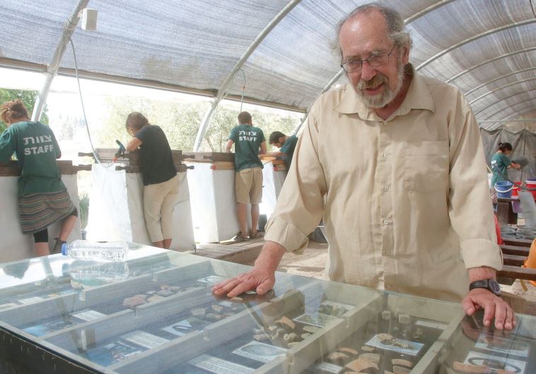 Barkay looks over priceless pieces of debris believed to date back to the First Temple period