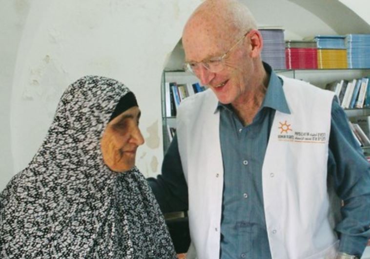 DR. WALDEN REASSURES a Palestinian woman after treating her and providing prescriptions.