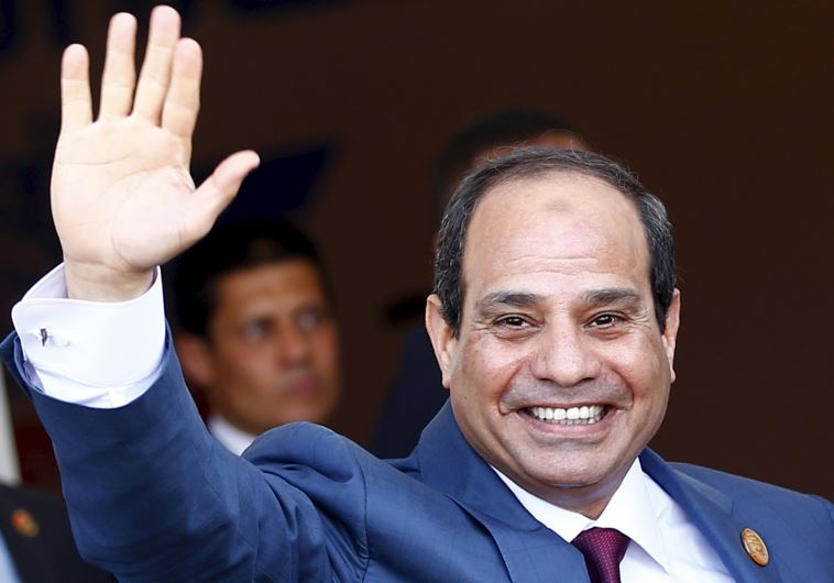Egyptian President Abdel Fattah al-Sisi waves as he arrives to the opening ceremony of the New Suez Canal