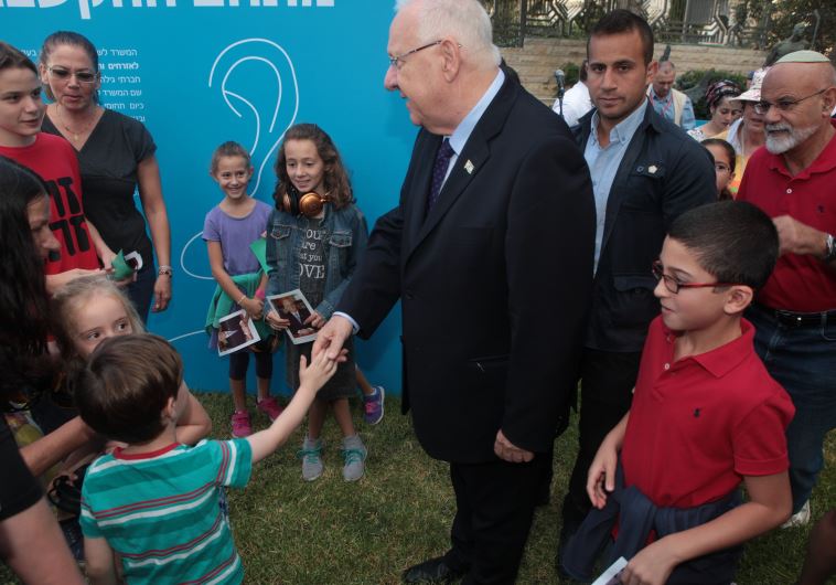 President Reuven Rivlin greets children at his home in Jerusalem on Succot