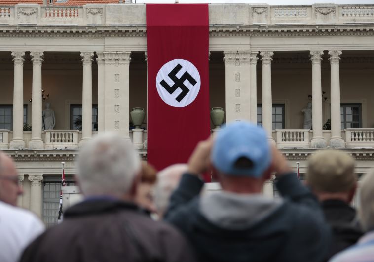 A Nazi swastika banner hangs on the facade of the Prefecture Palace in Nice which is being used as part of a movie set during the filming of a WWII film in the old city of Nice, France