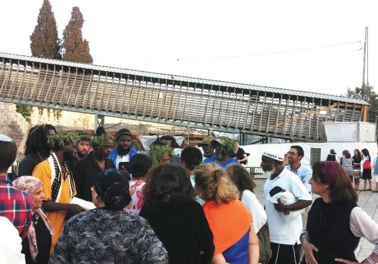 At the charged atmosphere of the Western Wall: Simhat Torah celebrants, tourists and a group of pilgrims from Papua New Guinea