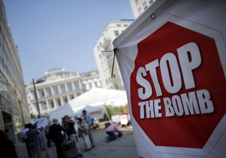 A sign which reads "Stop the Bomb" is seen as protesters gather outside the hotel where the Iran nuclear talks were being held in Vienna