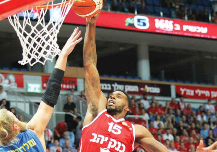 Hapoel Jerusalem forward Donta Smith goes up for a dunk in a game against Maccabi Ashdod