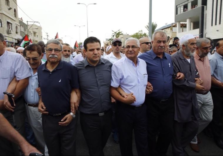 Arab lawmakers and public officials lead a protest in the northern town of Sakhnin