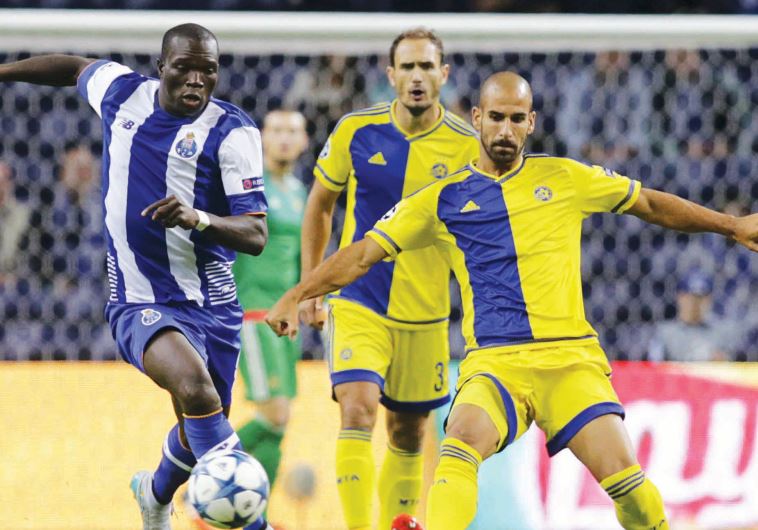 Porto forward Vincent Aboubakar (left) scored the opening goal last night against Gal Alberman (right)