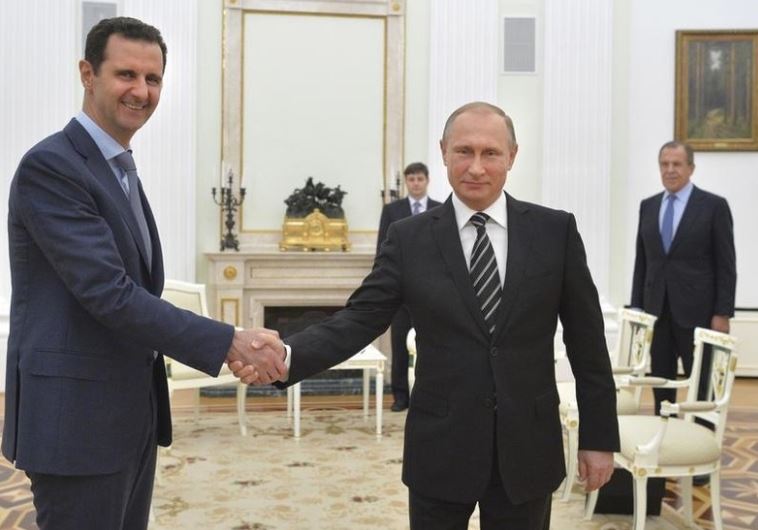 Russian President Vladimir Putin (R) shakes hands with Syrian President Bashar Assad at the Kremlin in Moscow, Russia, October 20, 2015