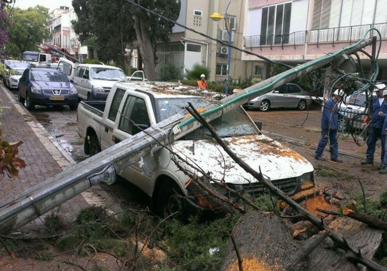 Storm downs electrical pole on a car in central Israel