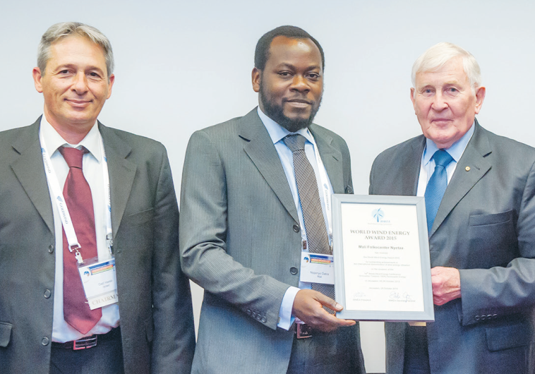 THE WORLD WIND ENERGY AWARD 2015 is presented to Mali-Folkecenter Nyetaa representative Nopenyo Dabla (second left) by WWEA president Peter Rae at the World Wind Energy Conference in Jerusalem yesterday. Also pictured are WWEA vice president and Israel WEA chairman Gadi Hareli (left) and WWEA secret