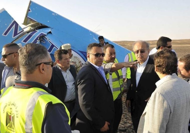 Egypt's Prime Minister Sherif Ismail (4rth R) at the remines of a plane crash at the desert in central Sinai near El Arish city north of Egypt, October 31, 2015