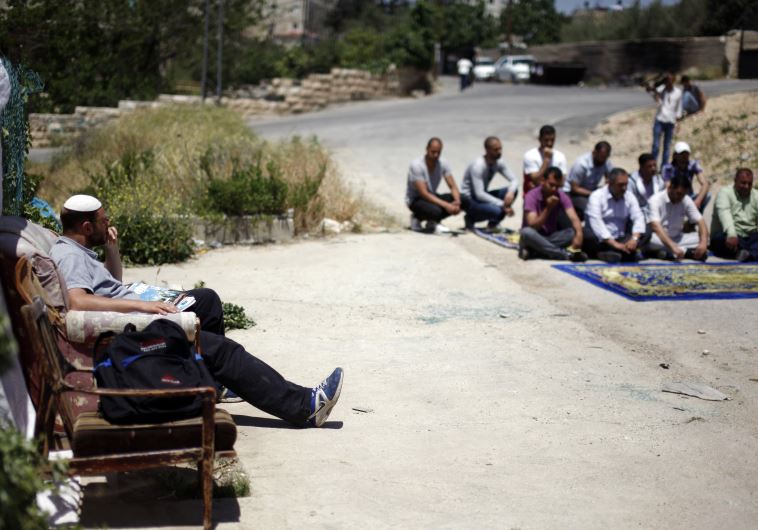 Palestinians take part in Friday prayers in East Jerusalem's Beit Hanina neighbourhood