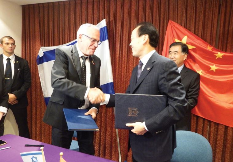 AGRICULTURE MINISTER Uri Ariel and Chinese Deputy Agriculture Minister Yu Xinrong shake hands after signing an agricultural development plan on Thursday.