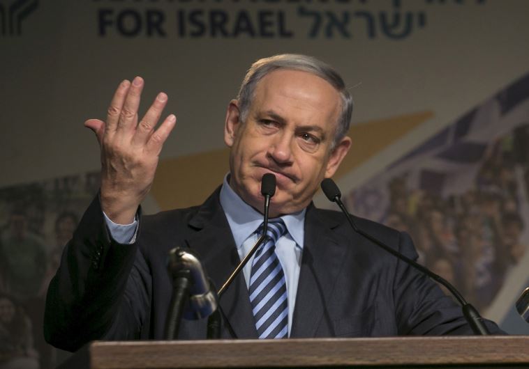 Prime Minister Benjamin Netanyahu gestures as he give an address