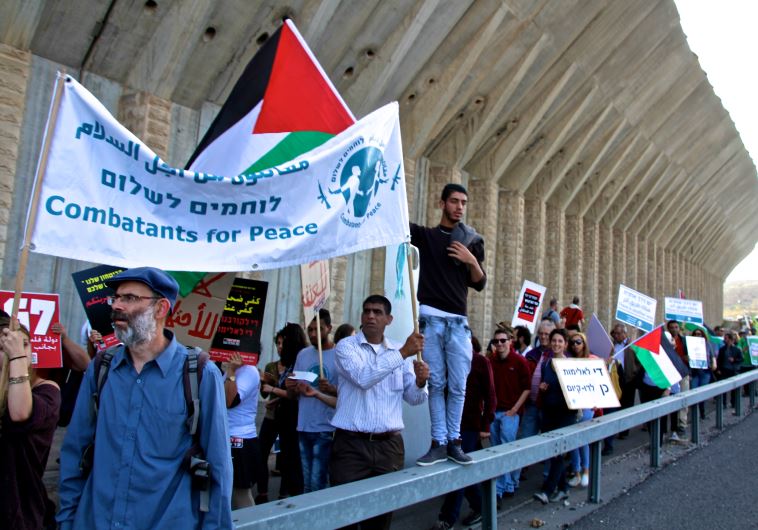 Israelis and Palestinian rally for peace along Route 60 in the West Bank on Friday