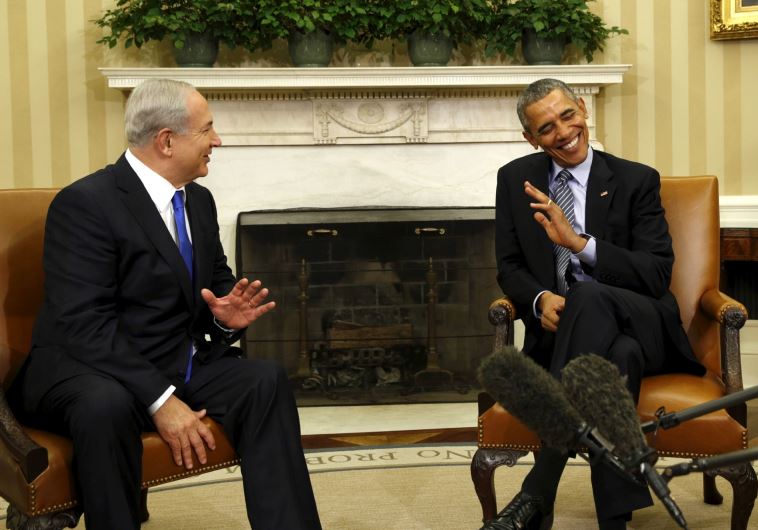 Prime Minister Benjamin Netanyahu shares a joke with US President Barack Obama during their meeting in the Oval office of the White House, in Washington