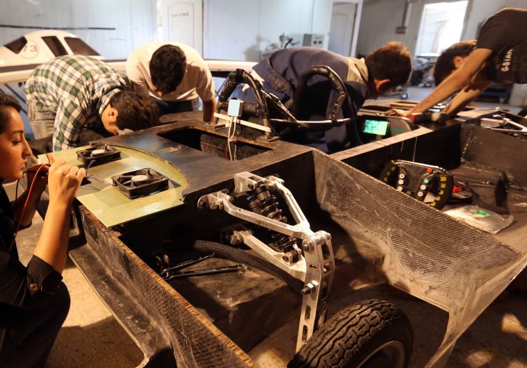 Students at Qazvin Azad Islamic University, west of Tehran, assemble a solar-powered Havin-2 vehicle for a test drive
